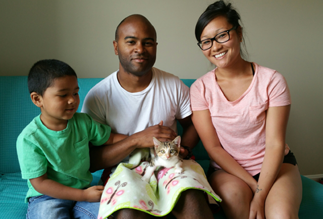 family holding their adopted cat